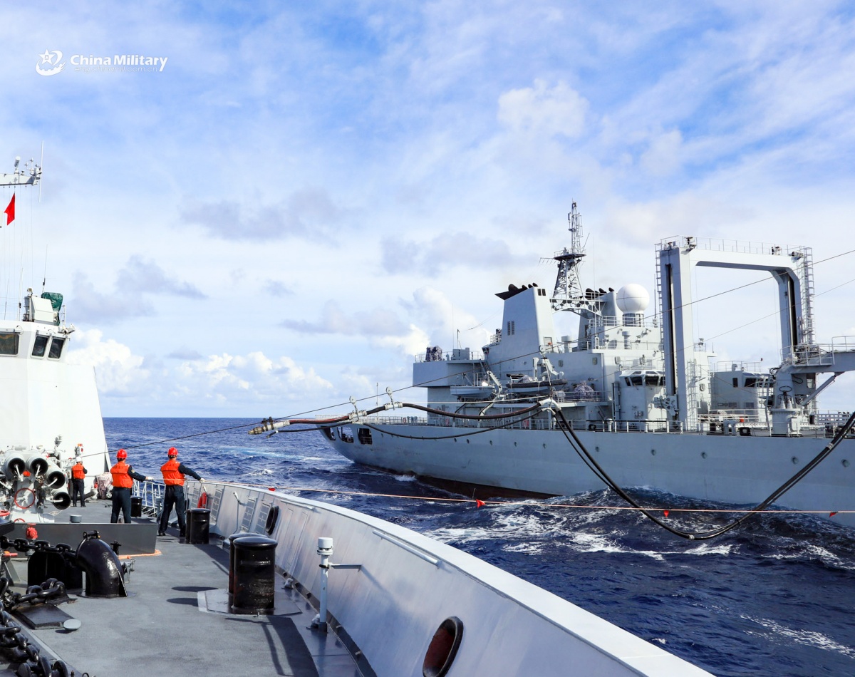 Naval vessels conduct alongside replenishment at sea